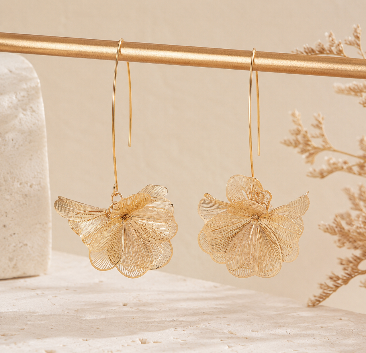9ed75a1c-9070-42c7-87cc-7eed0a87eb3c Pendientes largos en forma de flor con acabado dorado brillante, ligeros y con un diseño elegante y boho que ilumina cualquier look. Están fabricados en acero, lo que los hace resistentes y cómodos para llevar todo el día sin peso. Material: acero inoxidable Largo: 7 cm Ancho: 4,5 cm Diseño floral Ultra ligeros Alabama Shop